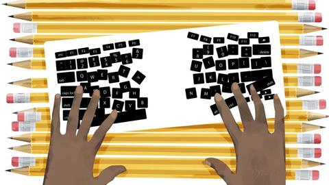 Person typing on top of pencils