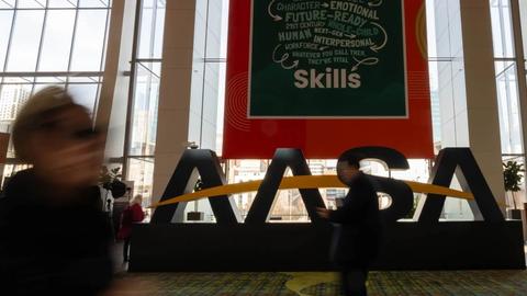 Person walking in front of AASA sign
